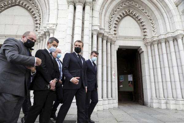 French President Emmanuel Macron, second right, Nice mayor Christian Estrosi, right, French Interior Minister Gerald Darmanin, second left, and Justice Minister Eric Dupond-Moretti arrive at Notre Dame church in Nice, southern France, Thursday, Oct. 29, 2020. An attacker armed with a knife killed at least three people at a church in the Mediterranean city of Nice, prompting the prime minister to announce that France was raising its security alert status to the highest level. It was the third attack in two months in France amid a growing furor in the Muslim world over caricatures of the Prophet Muhammad that were re-published by the satirical newspaper Charlie Hebdo. (Eric Gaillard/Pool via AP)