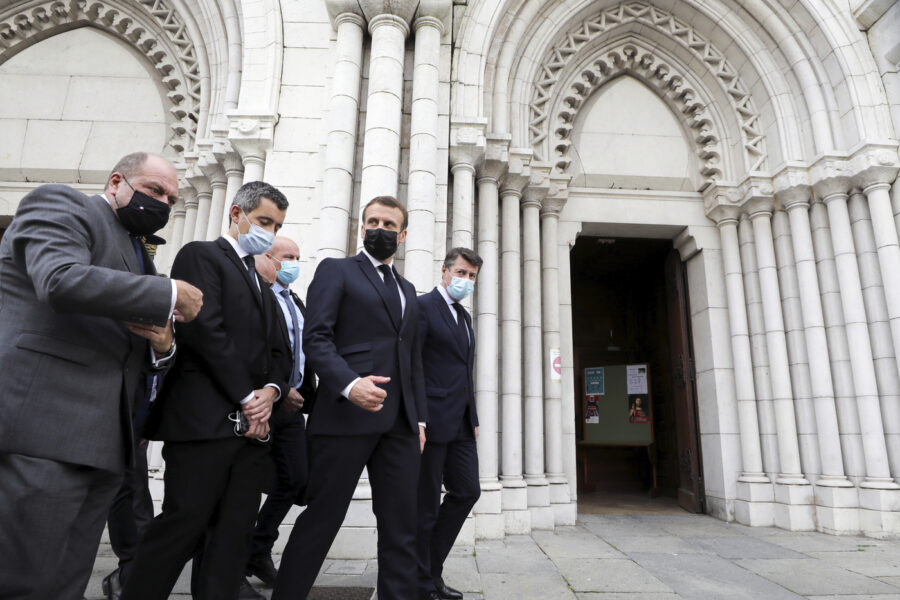 French President Emmanuel Macron, second right, Nice mayor Christian Estrosi, right, French Interior Minister Gerald Darmanin, second left, and Justice Minister Eric Dupond-Moretti arrive at Notre Dame church in Nice, southern France, Thursday, Oct. 29, 2020. An attacker armed with a knife killed at least three people at a church in the Mediterranean city of Nice, prompting the prime minister to announce that France was raising its security alert status to the highest level. It was the third attack in two months in France amid a growing furor in the Muslim world over caricatures of the Prophet Muhammad that were re-published by the satirical newspaper Charlie Hebdo. (Eric Gaillard/Pool via AP)