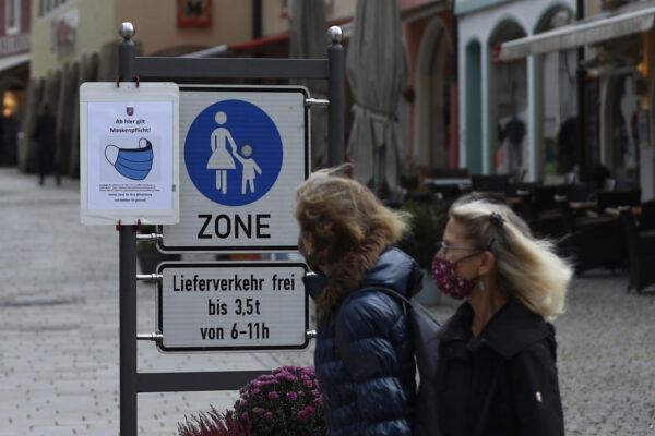 People pass a sign reading ‘Face masks mandatory from here’ in the deserted city of Berchtesgaden, Germany, Monday, Oct. 26, 2020. Authorities have posed the Berchtesgaden region under a lockdown since Oct. 20, 2020 due to a rising number of cases of the pandemic COVID-19 disease caused by the SARS-CoV-2 coronavirus in the district of Berchtesgadener Land. Local authorities in Bavaria’s Rottal-Inn county, on the border with Austria, said Monday that the restrictions will begin at midnight. (AP Photo/Matthias Schrader) People pass a sign reading ‘Face masks mandatory from here’ in the deserted city of Berchtesgaden, Germany, Monday, Oct. 26, 2020. Authorities have posed the Berchtesgaden region under a lockdown since Oct. 20, 2020 due to a rising number of cases of the pandemic COVID-19 disease caused by the SARS-CoV-2 coronavirus in the district of Berchtesgadener Land. Local authorities in Bavaria’s Rottal-Inn county, on the border with Austria, said Monday that the restrictions will begin at midnight. (AP Photo/Matthias Schrader)