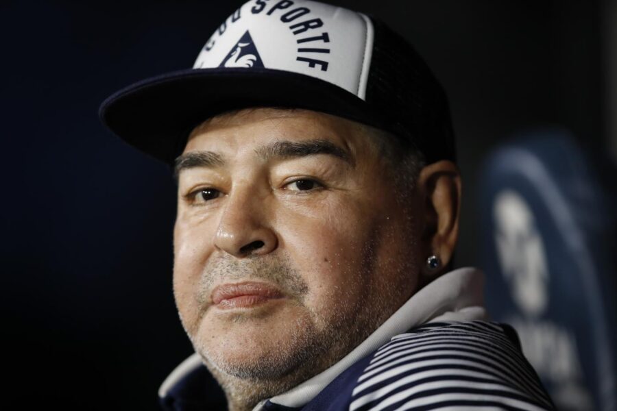 FILE – In this March 7, 2020 file photo, Diego Maradona, coach of Gimnasia y Esgrima, sits on the bench prior to Argentina’s soccer league match against Boca Juniors at La Bombonera stadium in Buenos Aires, Argentina. Maradona turns 60 on Friday, Oct. 30, 2020. (AP Photo/Natacha Pisarenko, File)
