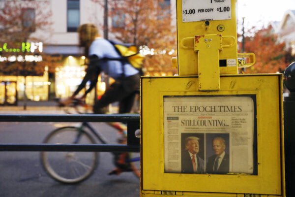 A newspaper from Thursday, Nov. 5 sits in a street box outside the Pennsylvania Convention Center in Philadelphia, where a handful of supporters of President Donald Trump continue to protest Monday, Nov. 9, 2020, two days after the election was called for Democrat Joe Biden. (AP Photo/Rebecca Blackwell)