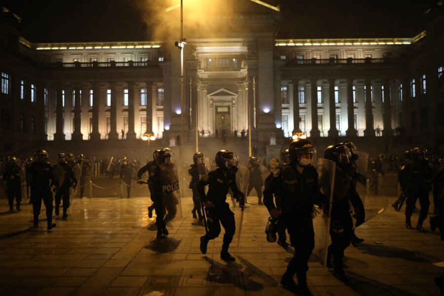 Police advance on protesters against the removal of President Martin Vizcarra, outside the Justice Palace in Lima, Peru, Thursday, Nov. 12, 2020. On Tuesday, Peru swore-in Manuel Merino as Peru’s new president, after the legislature voted Vizcarra out of office on Monday. (AP Photo/Rodrigo Abd)