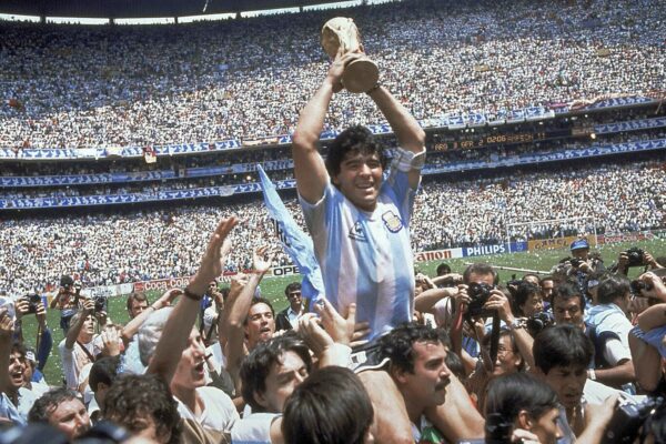 FILE – In this June 29, 1986 file photo, Diego Maradona holds up his team’s trophy after Argentina’s 3-2 victory over West Germany at the World Cup final soccer match at Atzeca Stadium in Mexico City. The Argentine soccer great who was among the best players ever and who led his country to the 1986 World Cup title before later struggling with cocaine use and obesity, has died. He was 60. (AP Photo/Carlo Fumagalli, File)