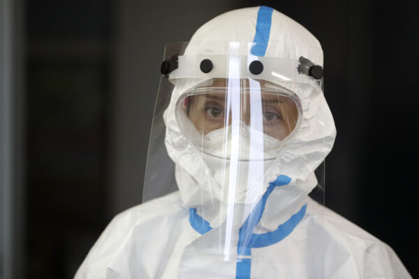 Volunteer dressed in a personal protective suit attends a one-day training organized by Czech Red Cross in Jablonec nad Nisou, Czech Republic, Saturday, Oct. 31, 2020. After the training the volunteers will able to assist medical personnel in hospitals and nursing homes. Over 15,000 medical staff in the country’s hospitals have been tested positive for the coronavirus while a number of hospitalized patients has been rising amid a record surge in coronavirus infections. (AP Photo/Petr David Josek)