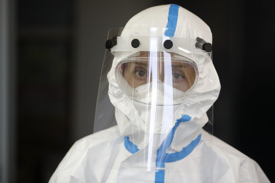 Volunteer dressed in a personal protective suit attends a one-day training organized by Czech Red Cross in Jablonec nad Nisou, Czech Republic, Saturday, Oct. 31, 2020. After the training the volunteers will able to assist medical personnel in hospitals and nursing homes. Over 15,000 medical staff in the country’s hospitals have been tested positive for the coronavirus while a number of hospitalized patients has been rising amid a record surge in coronavirus infections. (AP Photo/Petr David Josek)