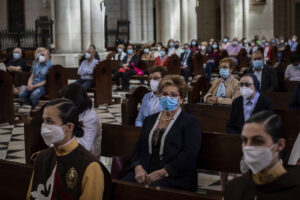 Catholic worshippers, wearing protective face masks as a measure to help curb the spread of the new coronavirus, attend a holy Corpus Christ mass inside the Almudena cathedral in Madrid, Spain, Sunday, June 14, 2020. (AP Photo/Bernat Armangue)