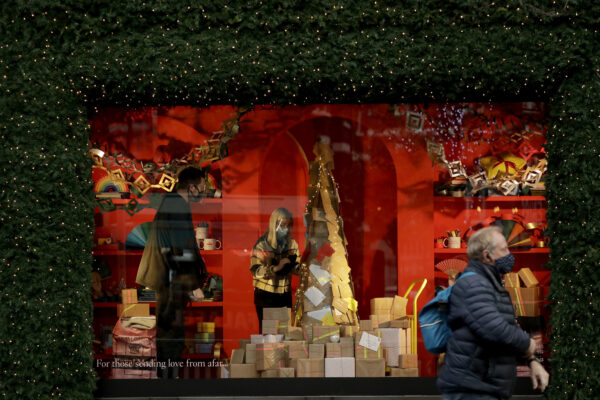 Staff arrange a window display before the Selfridges department opened for the day’s trading as non-essential shops are allowed to reopen after England’s second lockdown ended at midnight, on Oxford Street, in London, Wednesday, Dec. 2, 2020. (AP Photo/Matt Dunham)