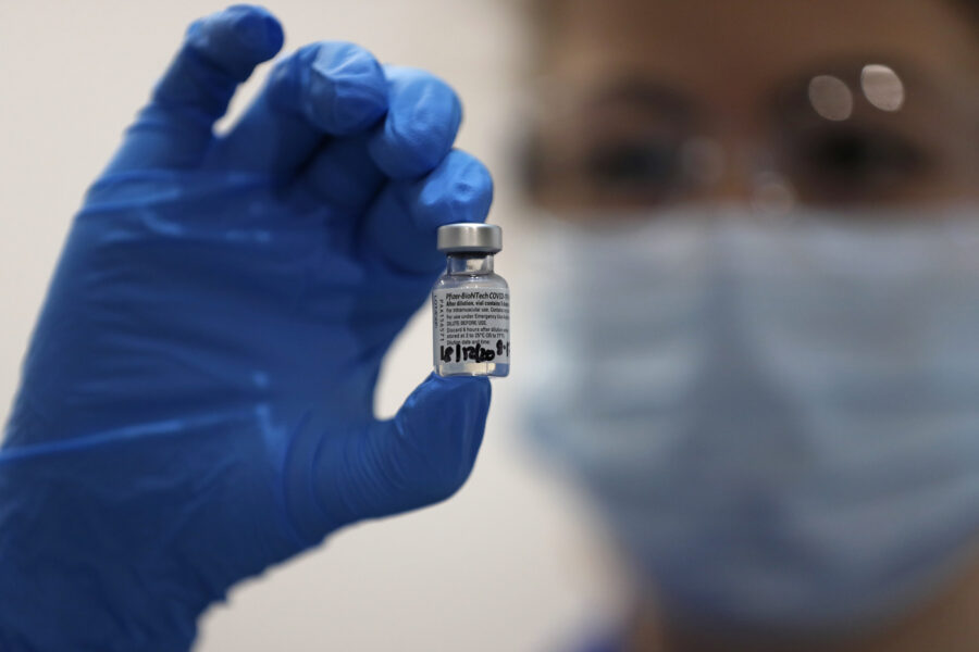 A nurse holds a phial of the Pfizer-BioNTech COVID-19 vaccine at Guy’s Hospital in London, Tuesday, Dec. 8, 2020. U.K. health authorities rolled out the first doses of a widely tested and independently reviewed COVID-19 vaccine Tuesday, starting a global immunization program that is expected to gain momentum as more serums win approval. (AP Photo/Frank Augstein, Pool)
