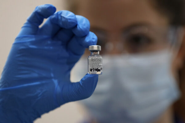 A nurse holds a phial of the Pfizer-BioNTech COVID-19 vaccine at Guy’s Hospital in London, Tuesday, Dec. 8, 2020. U.K. health authorities rolled out the first doses of a widely tested and independently reviewed COVID-19 vaccine Tuesday, starting a global immunization program that is expected to gain momentum as more serums win approval. (AP Photo/Frank Augstein, Pool)