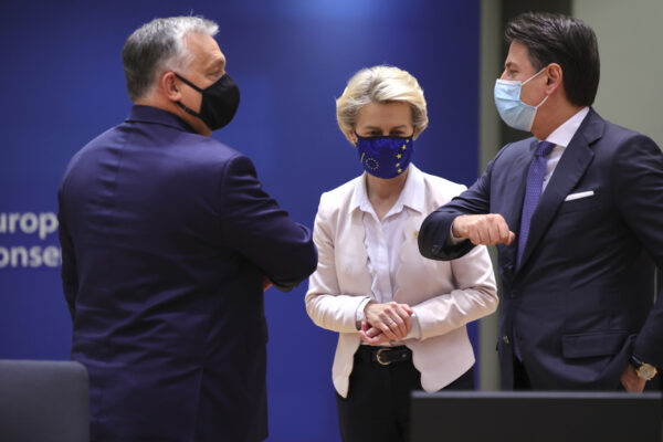 European Commission President Ursula von der Leyen, center, looks on as Hungary’s Prime Minister Viktor Orban, left, greets Italy’s Prime Minister Giuseppe Conte during a round table meeting at an EU summit in Brussels, Thursday, Dec. 10, 2020. European Union leaders meet for a year-end summit that will address anything from climate, sanctions against Turkey to budget and virus recovery plans. Brexit will be discussed on the sidelines. (AP Photo/Olivier Matthys, Pool)