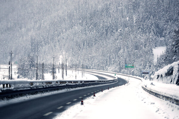 Snow covers trees at the deserted motorway A22 near the Austrian border in German speaking Italian province of South Tyrol in Brennero, northern Italy, Sunday, Dec. 13, 2020. (AP Photo/Matthias Schrader)