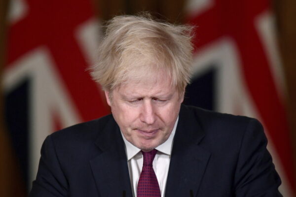 Britain’s Prime Minister Boris Johnson speaks during a news conference in response to the ongoing situation with the coronavirus (COVID-19) pandemic, inside 10 Downing Street, London, Saturday, Dec. 19, 2020. Johnson says Christmas gatherings can’t go ahead and non-essential shops must close in London and much of southern England as he imposed a new, higher level of coronavirus restrictions to curb rapidly spreading infections. (Toby Melville/Pool Photo via AP)