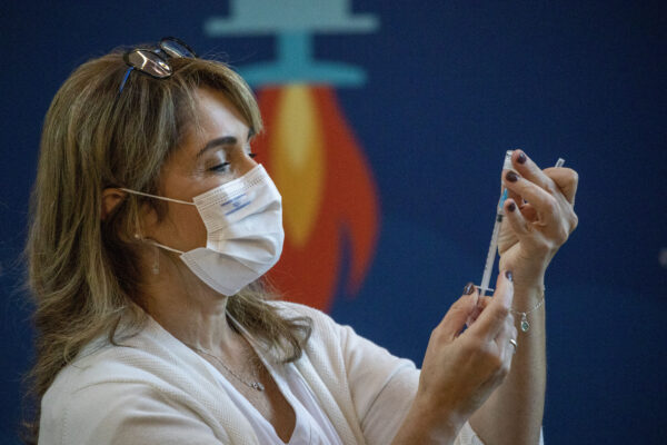 A medical staff member prepares a COVID-19 coronavirus vaccine at the Ichilov Hospital in Tel Aviv, Sunday, Dec. 20, 2020. (AP Photo/Ariel Schalit)
