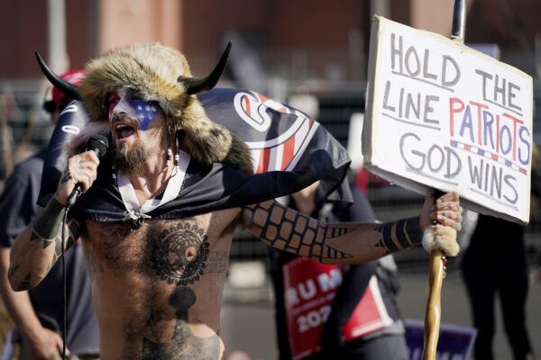 Jake Angeli, a supporter of President Donald Trump, speaks at a rally outside the Maricopa County Recorder’s Office Saturday, Nov. 7, 2020, in Phoenix. Democrat Joe Biden defeated President Donald Trump to become the 46th president of the United States on Saturday, positioning himself to lead a nation gripped by the historic pandemic and a confluence of economic and social turmoil. (AP Photo/Ross D. Franklin)