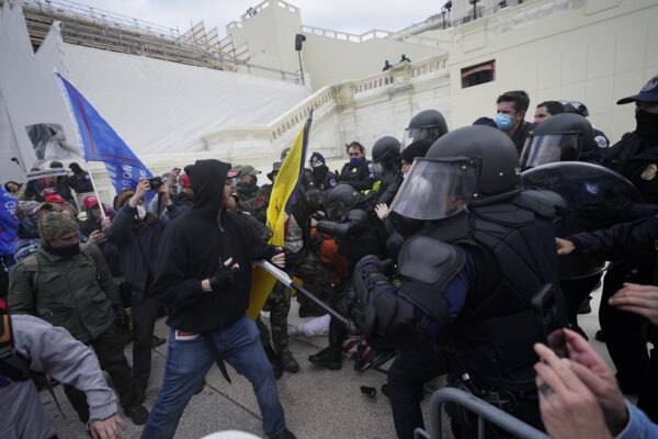 Trump supporters try to break through a police barrier, Wednesday, Jan. 6, 2021, at the Capitol in Washington. As Congress prepares to affirm President-elect Joe Biden’s victory, thousands of people have gathered to show their support for President Donald Trump and his claims of election fraud. (AP Photo/Julio Cortez)