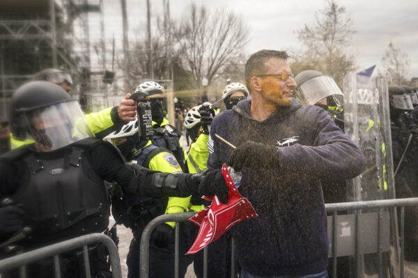 Trump supporters try to break through a police barrier, Wednesday, Jan. 6, 2021, at the Capitol in Washington. As Congress prepares to affirm President-elect Joe Biden’s victory, thousands of people have gathered to show their support for President Donald Trump and his claims of election fraud.(AP Photo/John Minchillo)