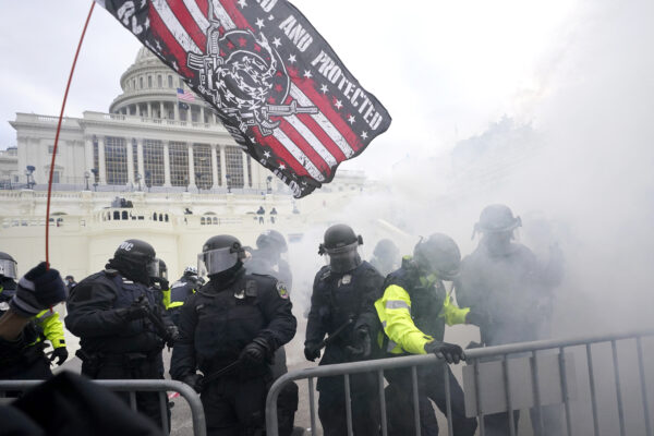Police hold off Trump supporters who tried to break through a police barrier, Wednesday, Jan. 6, 2021, at the Capitol in Washington. As Congress prepares to affirm President-elect Joe Biden’s victory, thousands of people have gathered to show their support for President Donald Trump and his claims of election fraud. (AP Photo/Julio Cortez)