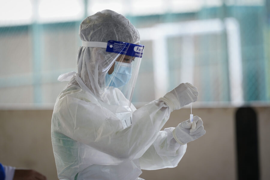 A medical worker collects a swab test sample during a coronavirus testing at a center for private COVID-19 testing in Petaling Jaya, Malaysia, on Monday, Feb. 1, 2021. Malaysian authorities imposed tighter restrictions on movement to try to halt the spread of the coronavirus. (AP Photo/Vincent Thian)
