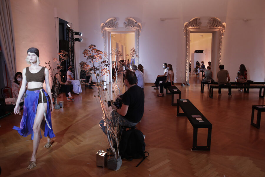 Respecting the social distances and wearing masks to protect against COVID-19 people look at Caterina Moro’s show,  part of the 2021 spring-summer collections presented during the Altaroma fashion shows in Rome, Thursday, Sep. 17, 2020. The COVID-19 pandemic has forced many fashion brands to rethink the way they will show their collections. (AP Photo/Alessandra Tarantino)