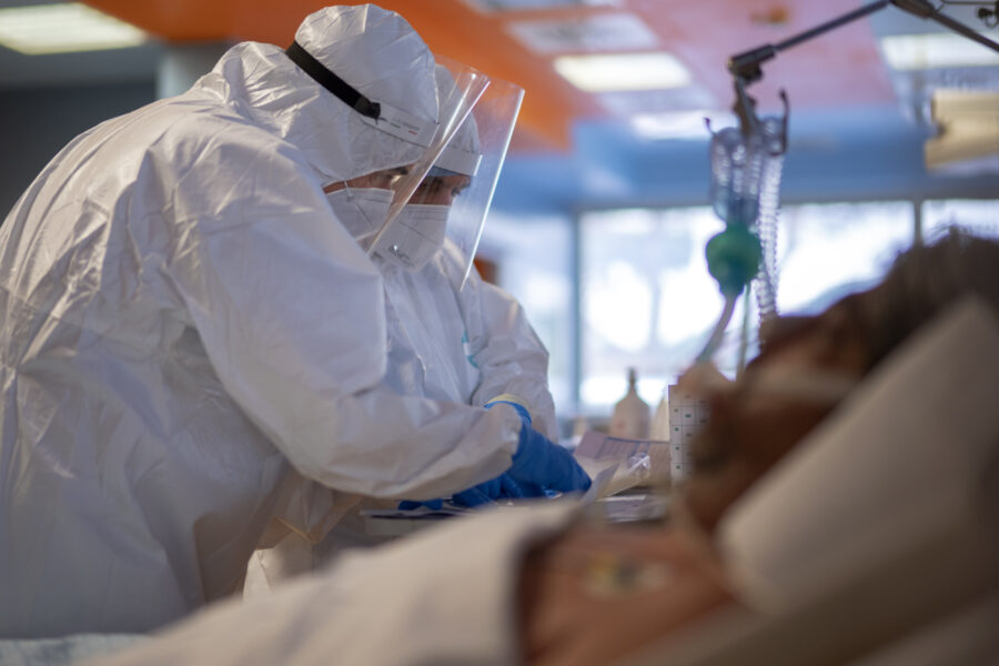 Head surgeon Sebastiano Petracca, right, and head nurse Mirco Perruzza, check the record for a patient with coronavirus in the ICU of the ICC Casalpalocco COVID-19 spoke hospital in Rome, Wednesday, Nov. 25, 2020. (AP Photo/Domenico Stinellis)