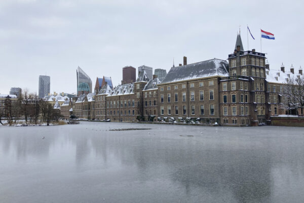 The frozen Hofvijver pond is seen outside the Dutch parliament buildings in The Hague, Netherlands, Tuesday, Feb. 9, 2021. With freezing temperatures forecast for more than a week in the Netherlands, ice fever is sweeping the nation, offering a welcome respite from grim coronavirus news while also creating a challenge for authorities trying to uphold social distancing measures. (AP Photo/Mike Corder)