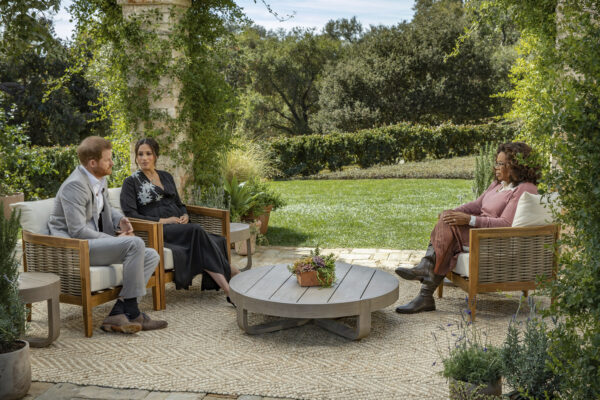 This image provided by Harpo Productions shows Prince Harry, from left, and Meghan, The Duchess of Sussex, in conversation with Oprah Winfrey. (Joe Pugliese/Harpo Productions via AP)