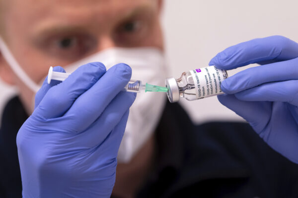 An employee prepares AstraZeneca’s Corona vaccine for vaccination at the police vaccination center in Munich, Germany, Tuesday, March 2, 2021. German federal state Bavaria start with the vaccinating of all police employees. (Sven Hoppe/dpa via AP)