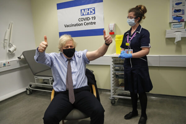 Britain’s Prime Minister Boris Johnson gestures after receiving the first dose of the AstraZeneca vaccine administered by nurse and Clinical Pod Lead, Lily Harrington at St.Thomas’ Hospital in London, Friday, March 19, 2021. Johnson is one of several politicians across Europe, including French Prime Minister Jean Castex, getting a shot of the AstraZeneca vaccine on Friday. (AP Photo/Frank Augstein, Pool)