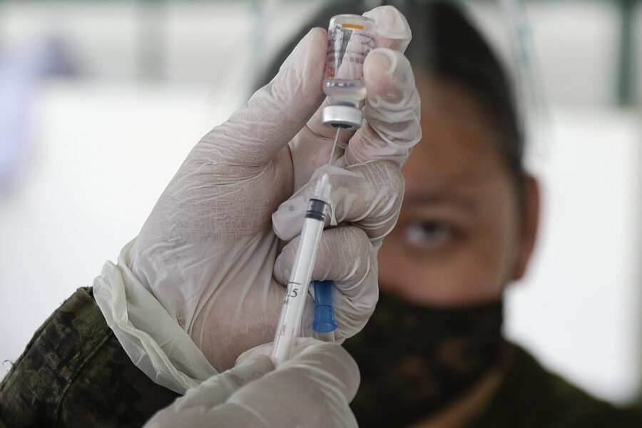 An army doctor prepares to inject the Sinovac vaccine from China during a vaccination at Fort Bonifacio, Metro Manila, Philippines on Tuesday, March 2, 2021. The Philippines launched a vaccination campaign to contain one of Southeast Asia’s worst coronavirus outbreaks but faces supply problems and public resistance, which it hopes to ease by inoculating top officials. (AP Photo/Aaron Favila)