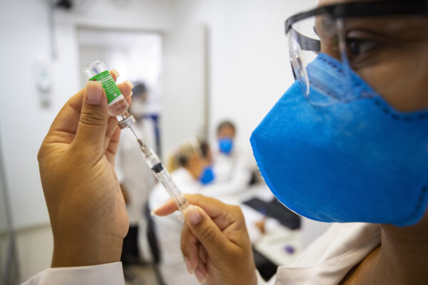 A nurse assistant prepares a dose of the Oxford-AstraZeneca vaccine for COVID-19 during a priority vaccination program for health workers at a community medical center in Sao Paulo, Brazil, Wednesday, Feb. 3, 2021. (AP Photo/Andre Penner)