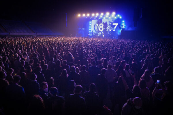 People attend a music concert in Barcelona, Spain, Saturday, March 27, 2021. Five thousand music lovers are set to attend a rock concert in Barcelona on Saturday after passing a same-day COVID-19 screening to test its effectiveness in preventing outbreaks of the virus at large cultural events. The show by Spanish rock group Love of Lesbian has the special permission of Spanish health authorities. While the rest of the country is limited to gatherings of no more than four people in closed spaces, the concertgoers will be able to mix freely while wearing face masks. (AP Photo/Emilio Morenatti)