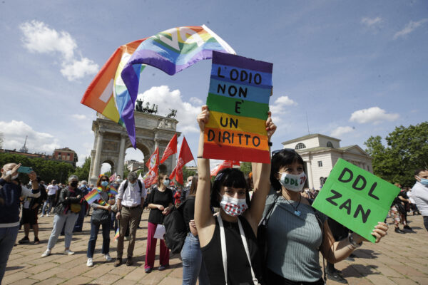 A woman holds a banner reading in Italian “Hate is not a right” during a demonstration to support a law proposal implementing prison punishment for those who commit crimes of discrimination based on sex, sex orientation, gender, gender identity, disability, in Milan, Italy, Saturday, May 8, 2021. The so-called Zan Law, named for a Democratic Party lawmaker and gay rights activist Alessandro Zan, would add women along with people who are gay, transgender or have disabilities to the classes of those already protected under a law banning discrimination and punishing hate crimes.(AP Photo/Luca Bruno)