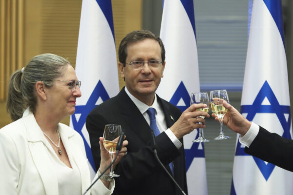 President-elect Isaac Herzog and his wife Michal celebrate after a special session of the Knesset whereby Israeli lawmakers elected the new president, at the Knesset, Israel’s parliament, in Jerusalem Wednesday, June 2, 2021. (Ronen Zvulun/Pool Photo via AP)