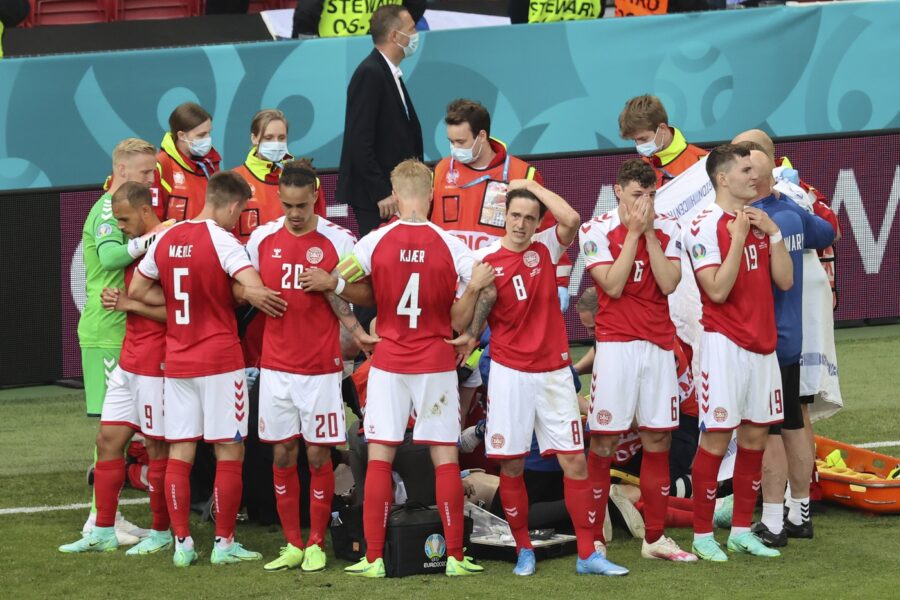 Denmark’s players react as their teammate Christian Eriksen lays on the ground during the Euro 2020 soccer championship group B match between Denmark and Finland at Parken stadium in Copenhagen, Denmark, Saturday, June 12, 2021. (Wolfgang Rattay/Pool via AP)