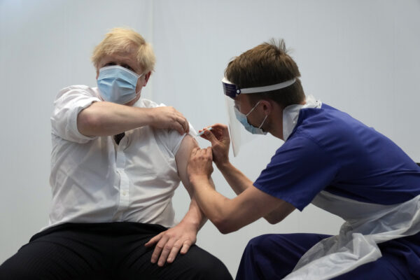 British Prime Minister Boris Johnson receives his second jab of the AstraZeneca coronavirus vaccine from James Black, at the Francis Crick Institute in London, Thursday, June 3, 2021. (AP Photo/Matt Dunham, Pool)
