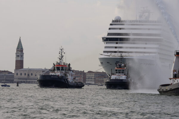 The the 92,409-ton,16-deck MSC Orchestra cruise ship exits the lagoon as St. Mark’s Square stands out in background, left, as it leaves Venice, Italy, Saturday, June 5, 2021. The first cruise ship leaving Venice since the pandemic is set to depart Saturday amid protests by activists demanding that the enormous ships be permanently rerouted out the fragile lagoon, especially Giudecca Canal through the city’s historic center, due to environmental and safety risks. (AP Photo/Antonio Calanni)
