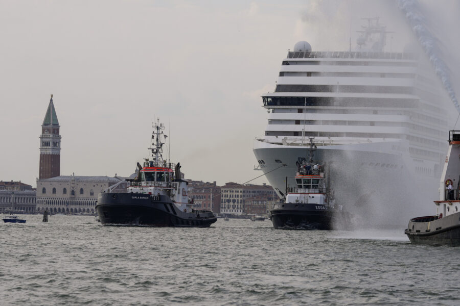 The the 92,409-ton,16-deck MSC Orchestra cruise ship exits the lagoon as St. Mark’s Square stands out in background, left, as it leaves Venice, Italy, Saturday, June 5, 2021. The first cruise ship leaving Venice since the pandemic is set to depart Saturday amid protests by activists demanding that the enormous ships be permanently rerouted out the fragile lagoon, especially Giudecca Canal through the city’s historic center, due to environmental and safety risks. (AP Photo/Antonio Calanni)