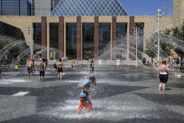 People cool off in the city hall pool, as temperatures hit 37 degrees Celsius in Edmonton, Alberta, on Wednesday, June 30, 2021. (Jason Franson/The Canadian Press via AP)