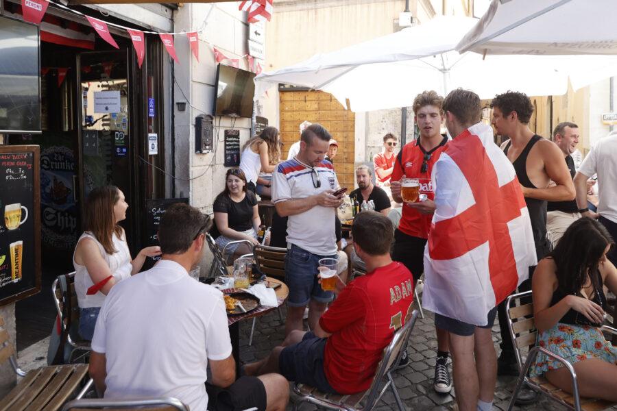 England fans enjoy a drink outside a pub hours before the start of the Euro 2020 soccer championship quarterfinal match between Ukraine and England, in Rome, Saturday, July 3, 2021. (AP Photo/Riccardo De Luca)