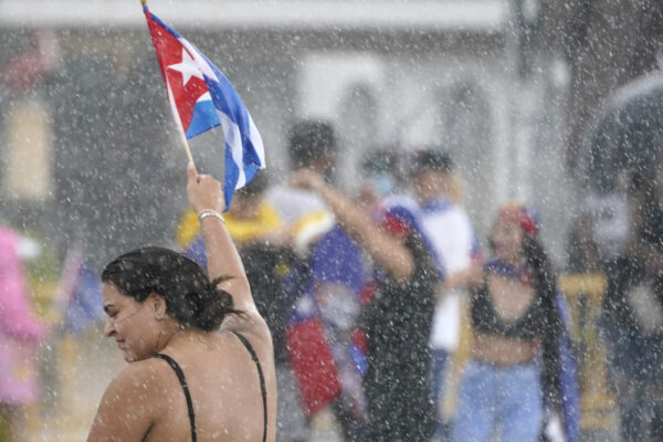 A demonstrator waves a Cuban flag in the rain, Wednesday, July 14, 2021, in Miami’s Little Havana neighborhood, as people rallied in support of antigovernment demonstrations in Cuba. (AP Photo/Wilfredo Lee) A demonstrator waves a Cuban flag in the rain, Wednesday, July 14, 2021, in Miami’s Little Havana neighborhood, as people rallied in support of antigovernment demonstrations in Cuba. (AP Photo/Wilfredo Lee)