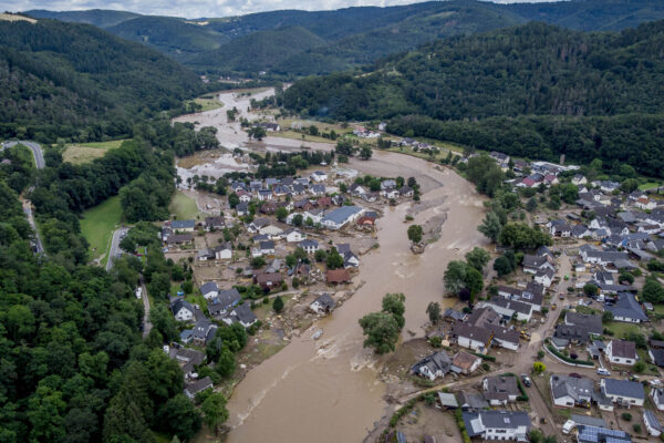 The Ahr river floats past destroyed houses in Insul, Germany, Thursday, July 15, 2021. Due to heavy rain falls the Ahr river dramatically went over the banks the evening before. (AP Photo/Michael Probst)