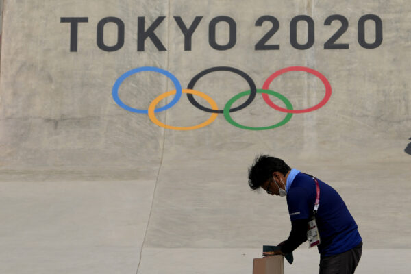 A worker prepares a rail at the skateboarding venue as preparations continue for the 2020 Summer Olympics, Tuesday, July 20, 2021, at the Ariake Urban Sports Park in Tokyo. (AP Photo/Charlie Riedel)