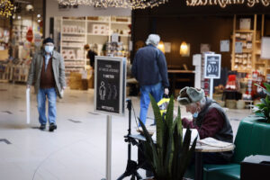 People shop in the Metropole Shopping Center in Hjoering, Denmark, Friday Nov. 6, 2020. More than a quarter million Danes have gone into lockdown in a northern region of the country where a mutated variation of the coronavirus has infected minks being farmed for their fur, leading to an order to kill millions of the animals. Prime Minister Mette Frederiksen said Friday’s move was contain the virus, and it came two days after the government ordered the cull of all 15 million minks bred at Denmark’s 1,139 mink farms. (Claus Bjoern Larsen/Ritzau Scanpix via AP)