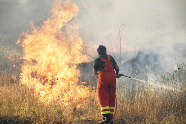 Volunteers try to control fire in the Municipality of Blufi, in the upper Madonie, near Palermo, Sicily, Italy, Tuesday Aug. 10, 2021, as  many wildfires continue plaguing the region. Sicily, Sardinia, Calabria and also central Italy, where temperatures are expected to reach record highs, were badly hit by wildfires. Climate scientists say there is little doubt that climate change from the burning of coal, oil and natural gas is driving extreme events, such as heat waves, droughts, wildfires, floods and storms. (AP Photo/Salvatore Cavalli)