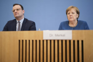 German Chancellor Angela Merkel, right, and Health Minister Jens Spahn attend a news conference about the coronavirus outbreak in Germany, in Berlin, Germany, Wednesday, March 11, 2020. For most people, the new coronavirus causes only mild or moderate symptoms, such as fever and cough. For some, especially older adults and people with existing health problems, it can cause more severe illness, including pneumonia. (AP Photo/Markus Schreiber)