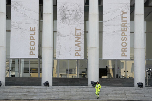 An Italian Civil protection volunteer walks outside the main entrance of the G20 summit media press center in Rome, Thursday, Oct. 28, 2021. A Group of 20 summit scheduled for this weekend in Rome is the first in-person gathering of leaders of the world’s biggest economies since the COVID-19 pandemic started. (AP Photo/Gregorio Borgia)