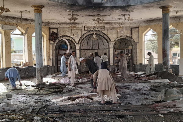 People view the damage inside of a mosque following a bombing in Kunduz, province northern Afghanistan, Friday, Oct. 8, 2021. A powerful explosion in the mosque frequented by a Muslim religious minority in northern Afghanistan on Friday has left several casualties, witnesses and the Taliban’s spokesman said. (AP Photo/Abdullah Sahil)