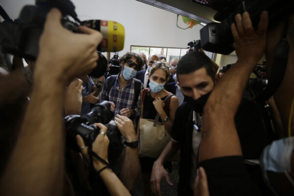 Aya Biran, center right, a paternal aunt of Eitan Biran, who survived a cable car crash in Italy that killed his immediate family, arrives to court in Tel Aviv on Thursday, Sept. 23, 2021 for a hearing in the alleged kidnapping of her nephew. The boy’s parents and younger sibling were among 14 killed in May when a cable car slammed into a mountainside in northern Italy. He is now the focus of a custody battle between his maternal grandparents in Israel and his paternal relatives in Italy. (AP Photo/Sebastian Scheiner)