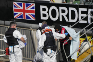 People thought to be migrants disembark from a British Border Force patrol boat after being picked up from a dingy in the English Channel in Dover harbour , England, Thursday, Sept. 16, 2021. (AP Photo/Alastair Grant)