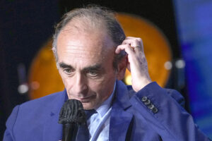 Hard-right political talk-show star Eric Zemmour gestures as he talks during a meeting to promote his latest book “La France n’a pas dit son dernier mot” (France has not yet said its last word) in Versailles, west of Paris, Tuesday, Oct. 19, 2021.Provocative anti-immigration commentator Eric Zemmour is drawing national attention in France as he floats a possible presidential bid that could shake up the campaign for the April election. (AP Photo/Michel Euler)